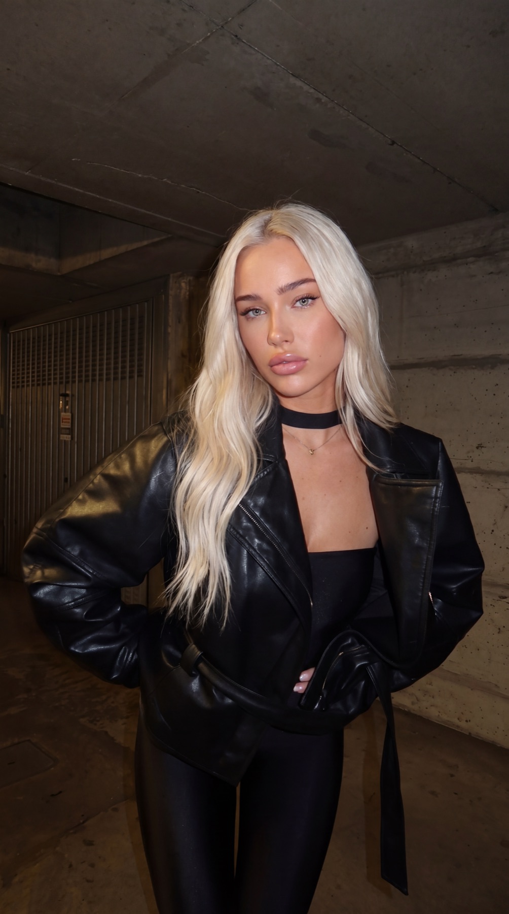 Viper Deme in a black leather jacket and choker — edgy night portrait in Miami